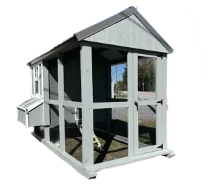 A rustic wooden chicken coop with a pitched roof, nestled among greenery.