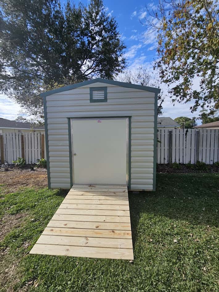 A variety of outdoor sheds displayed for sale, showcasing both new and used options.