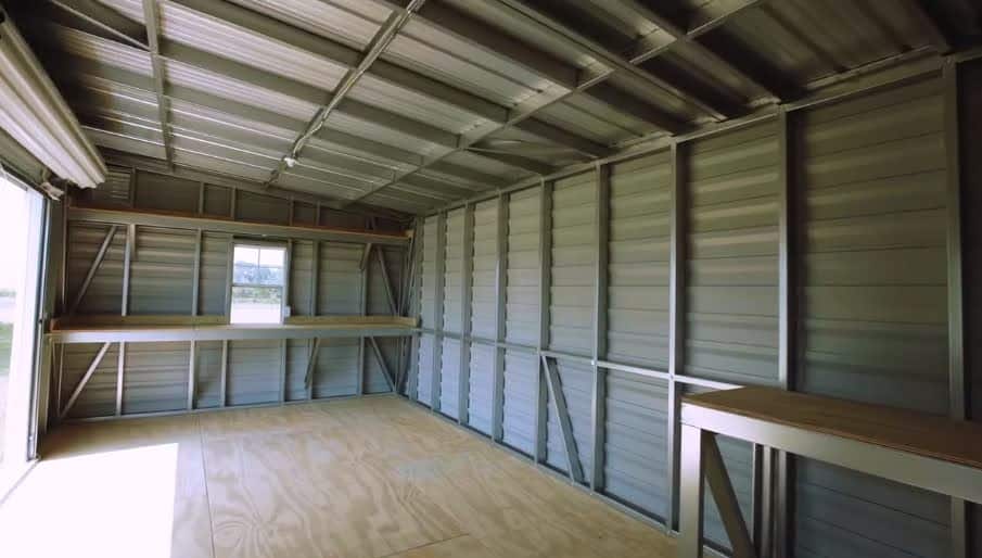 Backyard metal tool and wooden utility sheds with shelving and roll-up garage door