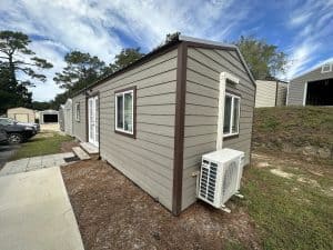 Fully finished shed, a tiny home office with AC, wooden shed with metal roof.