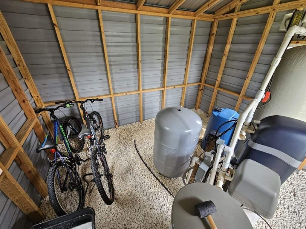 Outdoor bike storage shed with shelves for organizing tools and accessories