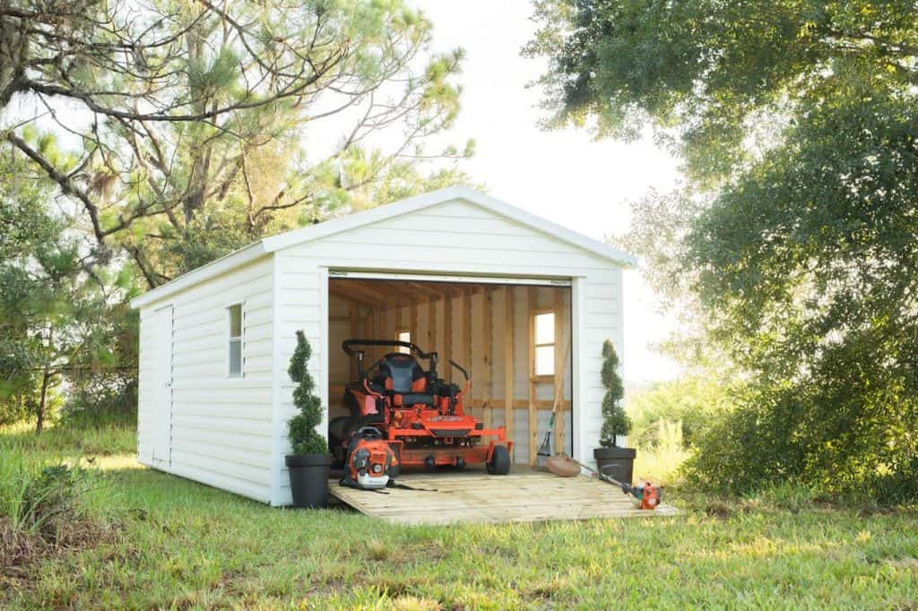 Riding lawn mower stored in a spacious shed