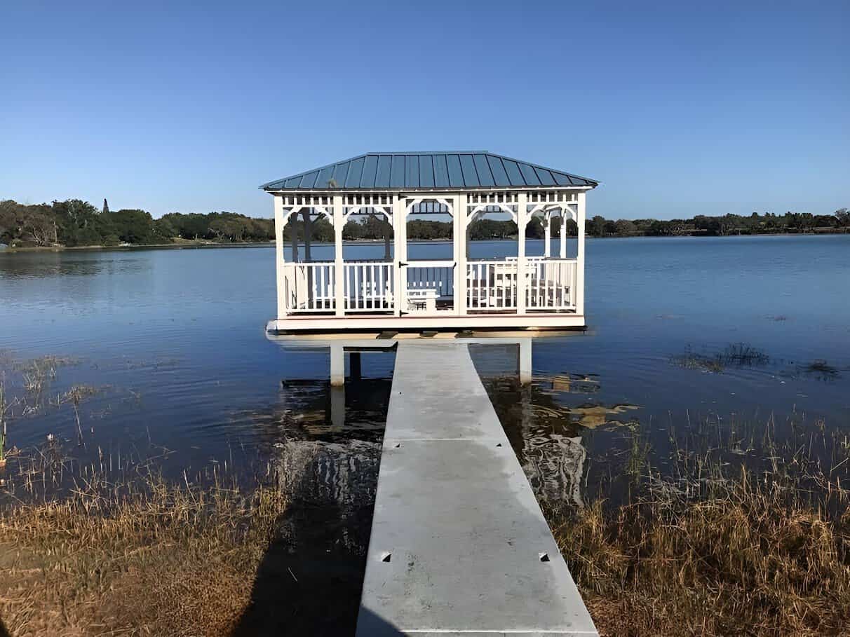 Wooden waterfront gazebo in Florida, offering a serene retreat by the water's edge.