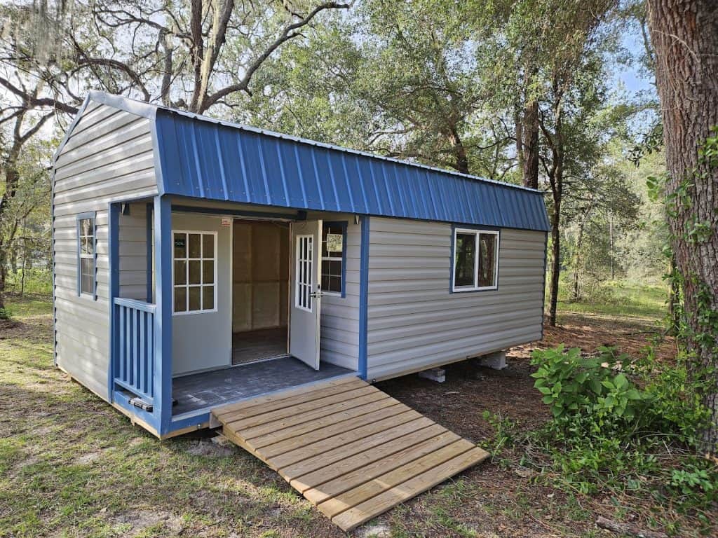 Wooden garden tool and utility sheds with double doors and metal roof, ideal for outdoor storage