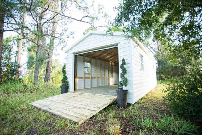 Finished bike shed with roll-up garage door for motorcycle storage in Astor