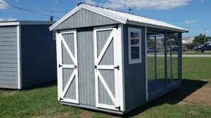 Wooden outdoor dog kennel and house from Robin Sheds for sale in Chattahoochee , seen from the back, showcasing sturdy construction and spacious design for canine comfort.