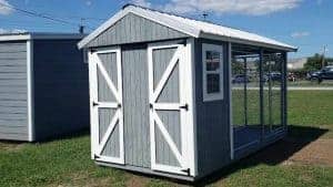Wooden outdoor dog kennel and house from Robin Sheds for sale in Cinco Bayou , seen from the back, showcasing sturdy construction and spacious design for canine comfort.