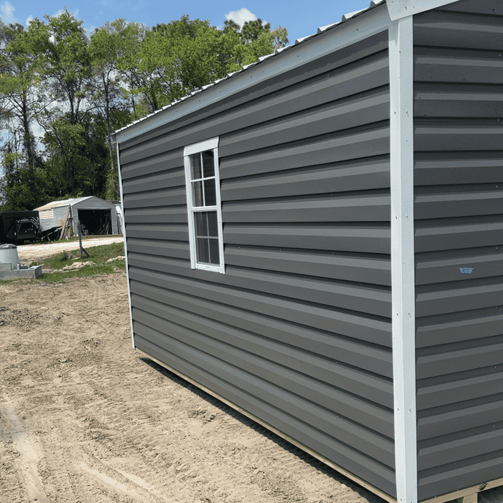 Side view of 10x16 Charcoal Steel Americana Shed showing White trim, Galvalume metal roof, colonial windows, and gable area