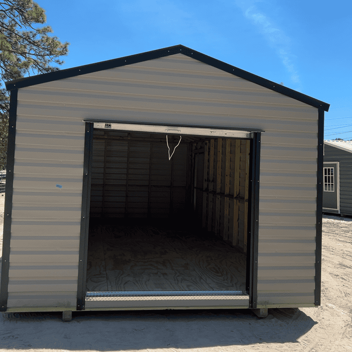 Front view of 12x24 Clay Steel Americana Shed with Galvalume roof and Black trim, featuring 72" roll-up coil door and 48" outswing door with three colonial windows