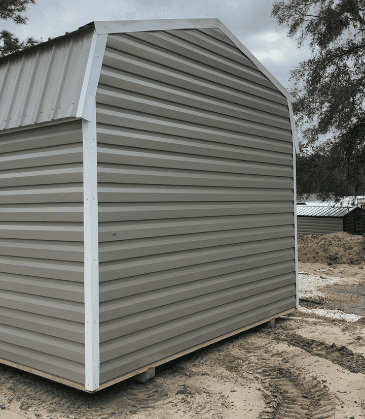 Rear view of 12x20 Clay Metal Gambrel Roof Cabin with white trim