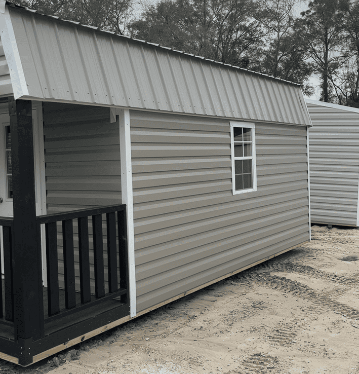 Side view of 12x20 Gambrel Cabin with 4' porch, white rails on 3 sides, Clay steel siding and Clay metal roof