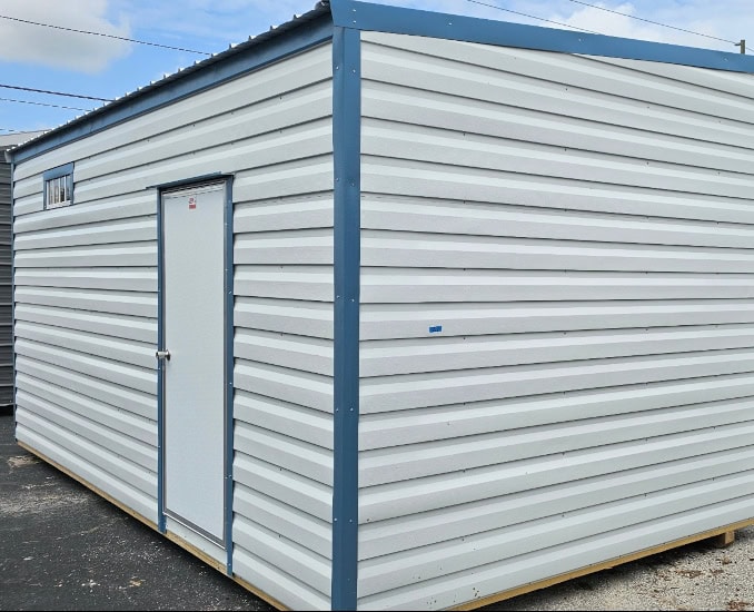 Front view of 10x20 White Vista Shed with Hawaiian Blue trim and Galvalume roof, featuring 36" outswing door, colonial window, and transom