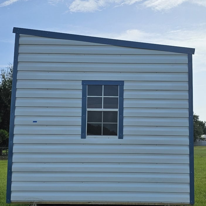 Side view of 10x20 White Vista Shed showing Hawaiian Blue trim, Galvalume metal roof, and 7.6 ft tall sidewalls