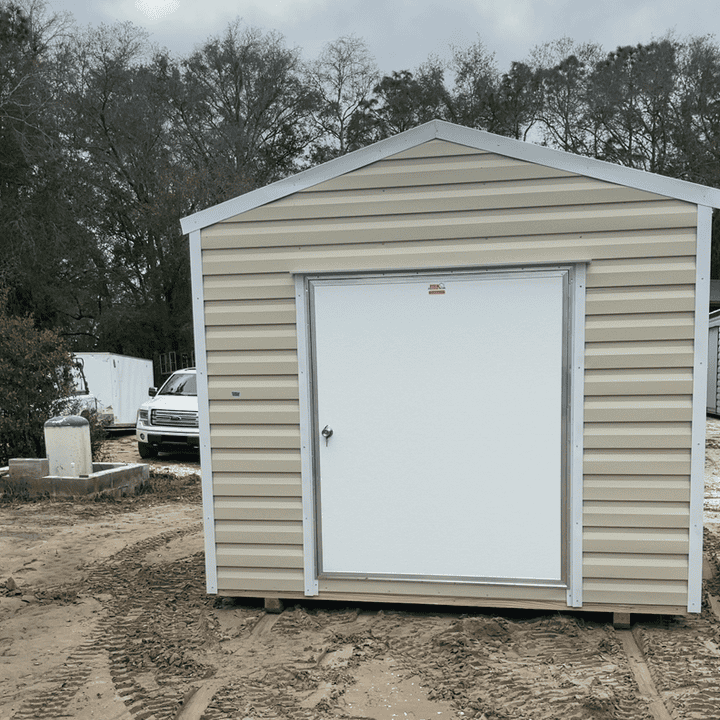 Front view of 10x12 Light Stone Steel Americana Shed with White trim and Galvalume roof, featuring 60" outswing door and two colonial windows