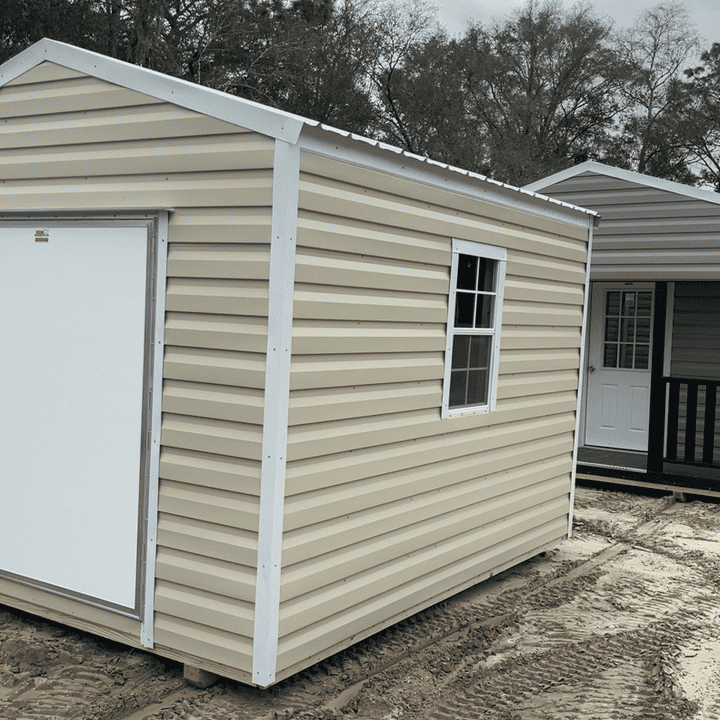 Side view of 10x12 Light Stone Steel Americana Shed showing White trim, Galvalume metal roof, and colonial windows