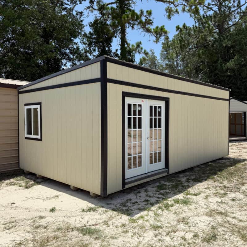 Front view of 14x24 Light Stone Vista Shed with Black trim and Charcoal roof, featuring 15-light French doors and multiple windows