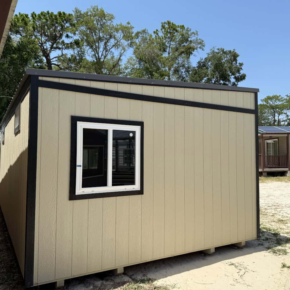 Right side view of 14x24 Light Stone Vista Shed showing Black trim, Charcoal metal roof, horizontal slide windows, and tall sidewalls