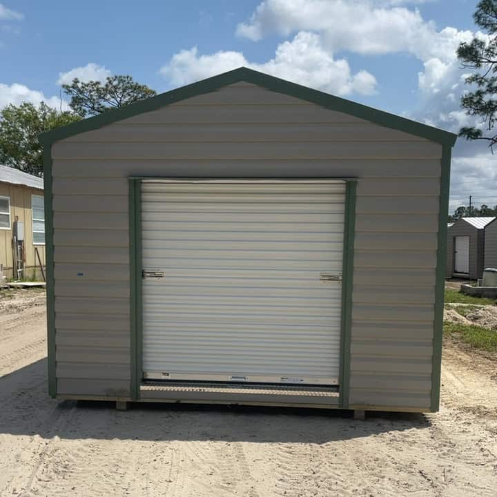 Front view of 12x20 Ash Gray Americana Steel Shed with Moss Green trim and large 72" roll-up coil door